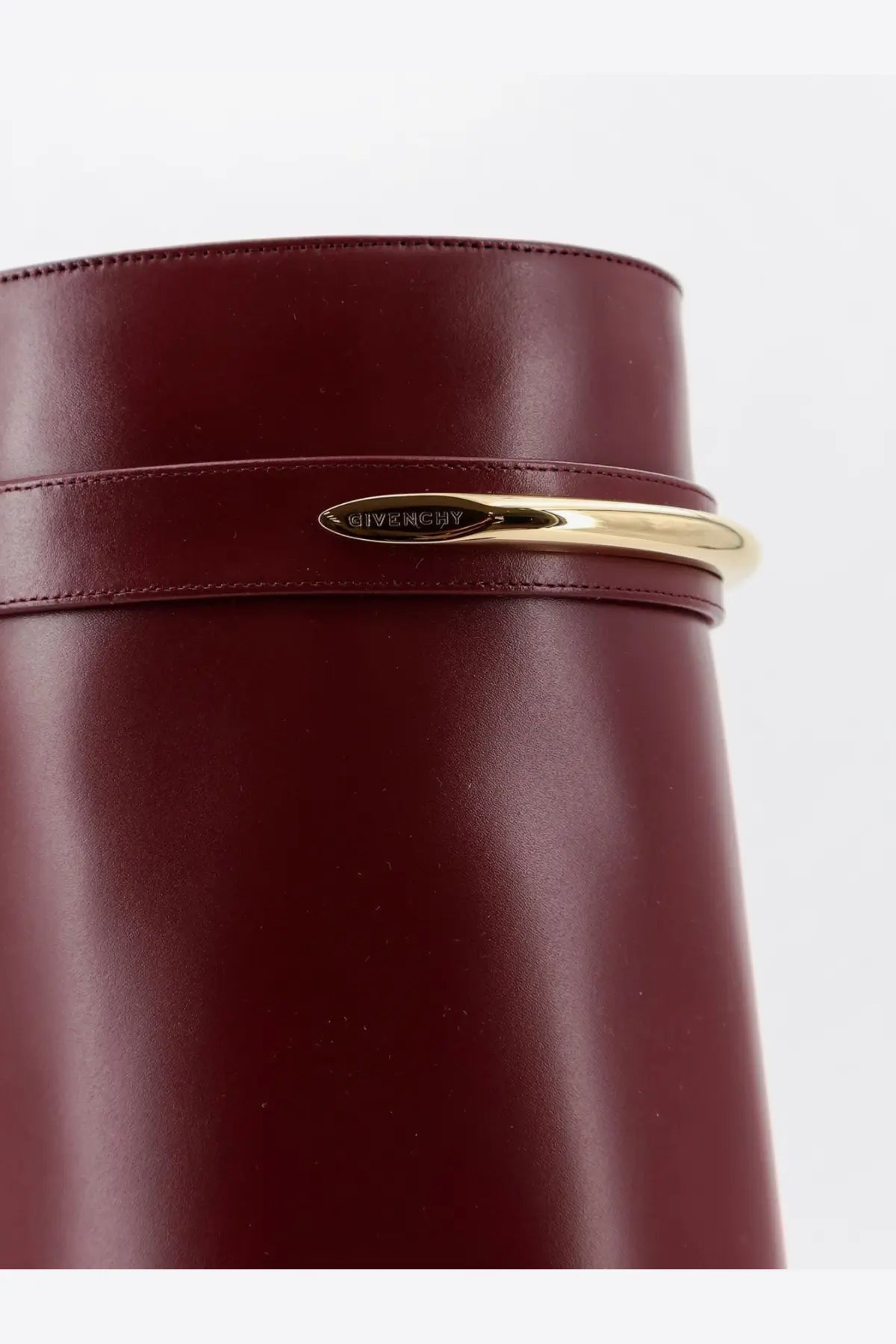 A sleek burgundy leather Givenchy bag with a polished gold-tone metal clasp for women’s shark leather boots red