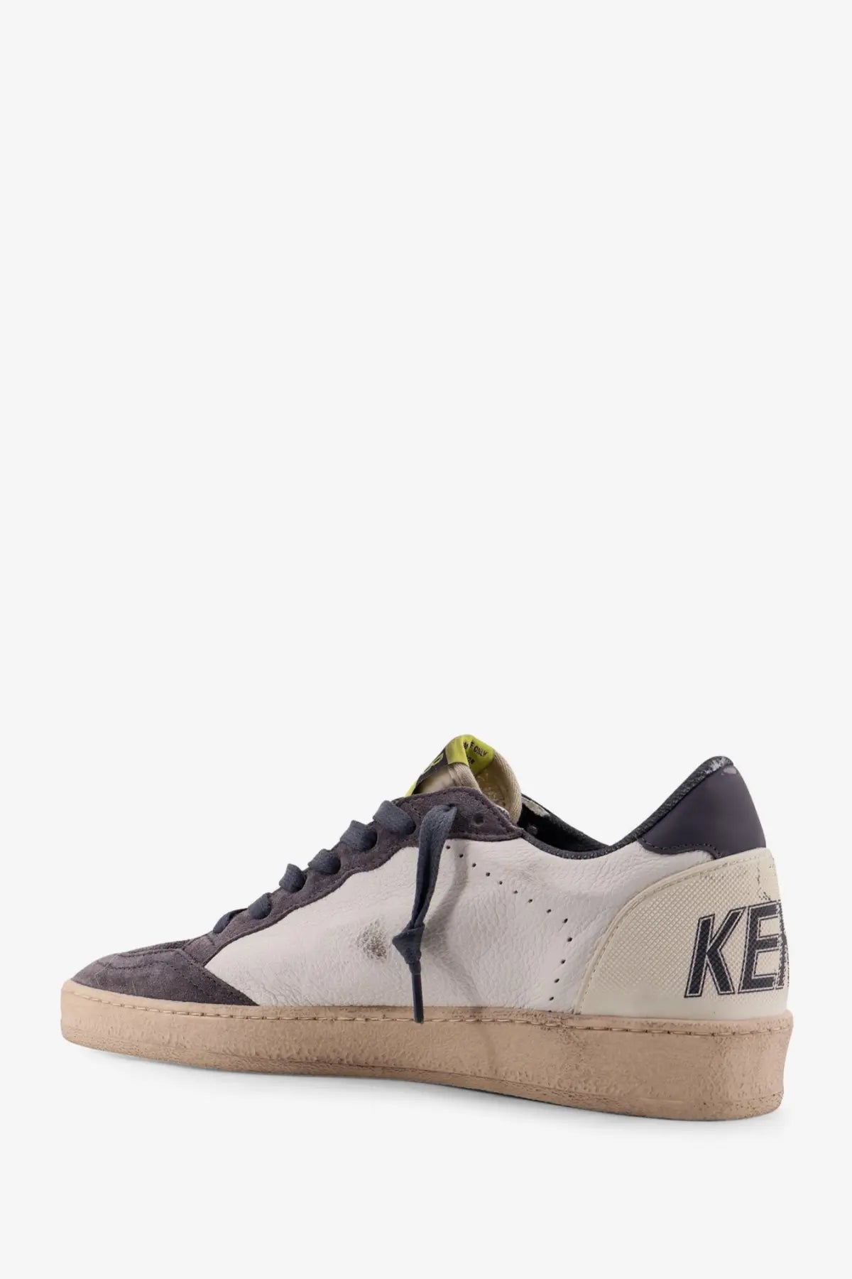 Back view of golden goose men’s ballstar white leather and dark gray suede low-top sneaker with distressed finish and black laces