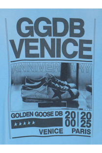 A pair of white leather sneakers with a black star logo classic laces and rubber sole styled with golden goose mens cotton shirt cristalseas