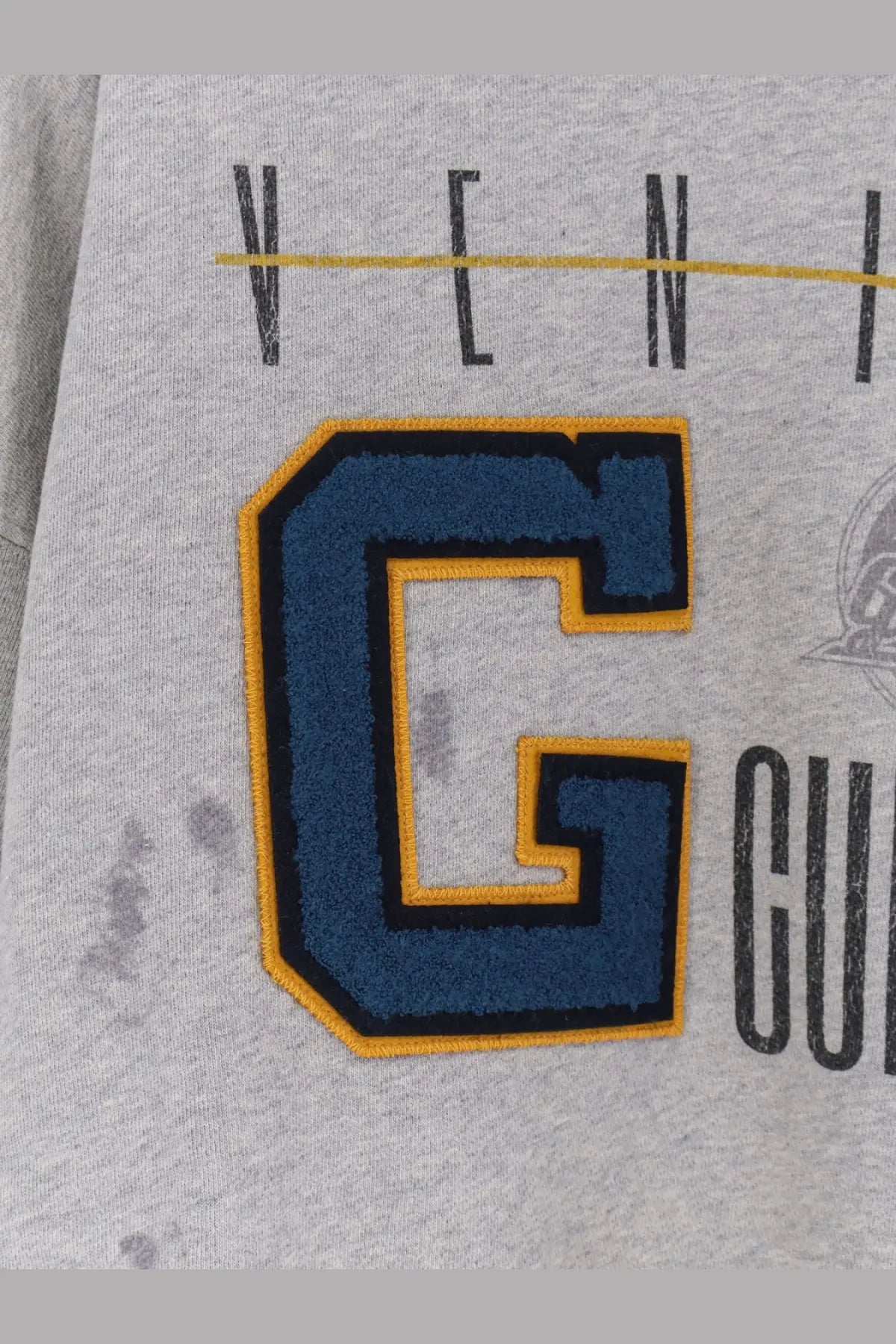 Golden Goose men’s gray cotton sweatshirt with bold embroidered blue letter c and yellow black trim on the front
