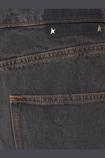 Back side of golden goose men’s ms pant cory loose skate jeans black with dark-wash denim and silver star studs above pocket