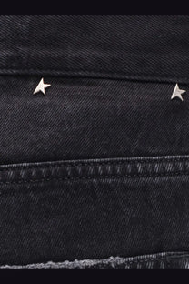 Silver star-shaped studs on dark black denim fabric of golden goose men’s skate black denim jeans
