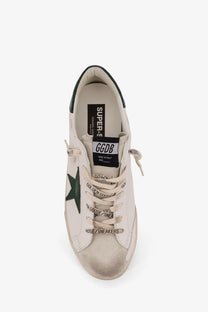 Golden Goose men’s superstar leather sneakers in white with a dark green star and black branding details