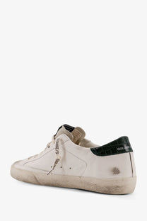 Golden Goose men’s superstar leather sneakers in white with distressed finish and black crocodile heel tab and side branding