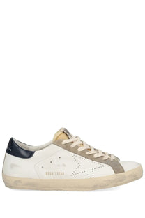 Golden Goose men’s superstar sneaker in white leather with distressed sole navy heel tab and beige suede star detail