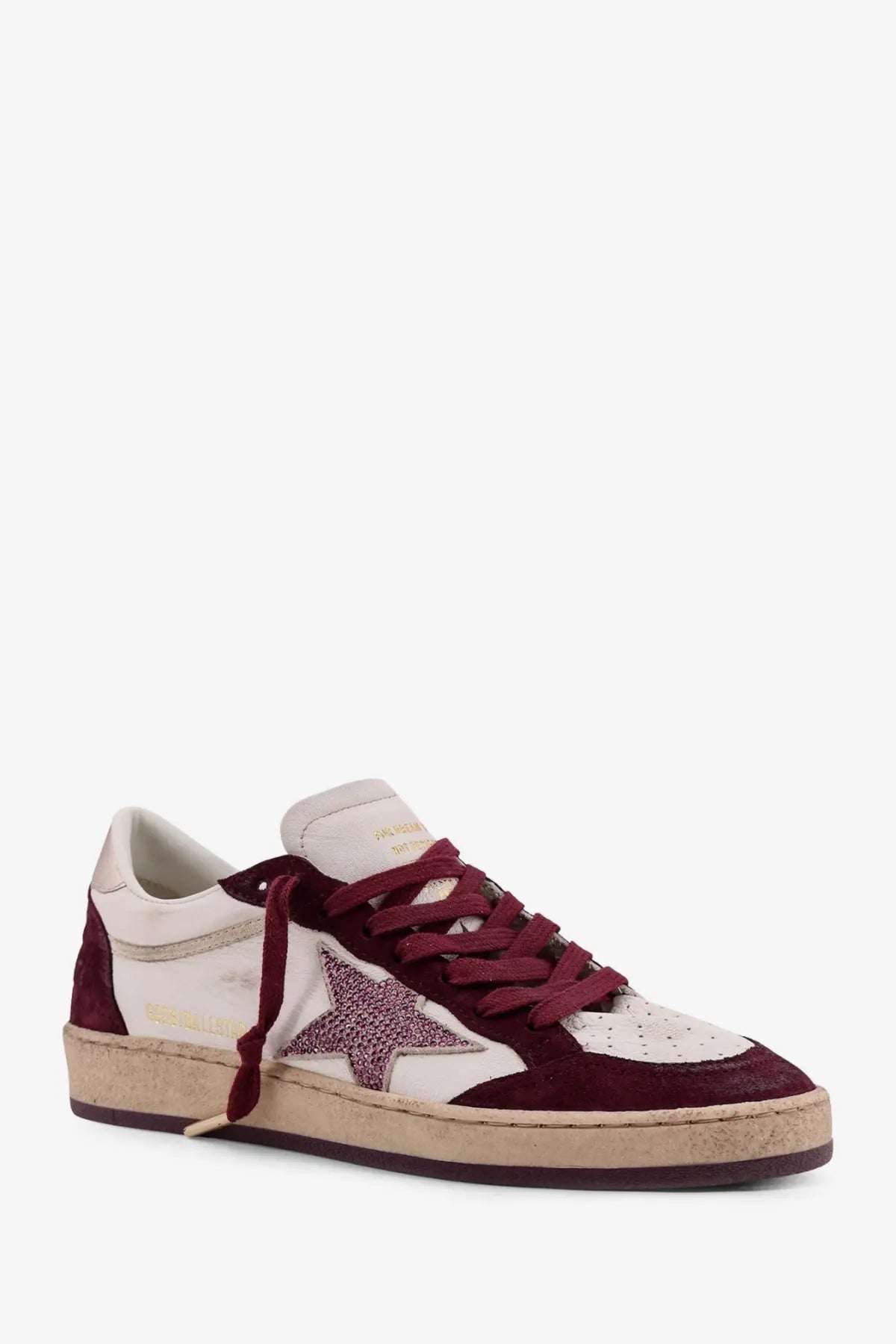 Golden Goose women’s Ballstar leather low-top sneaker in maroon and cream suede with a glittery star patch