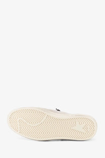 Cream-colored rubber sole with wavy tread and subtle embossed logo on golden goose women’s ballstar suede sneakers beige
