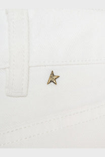 A small textured gold star pin on white fabric detail of golden goose women’s denim trousers white