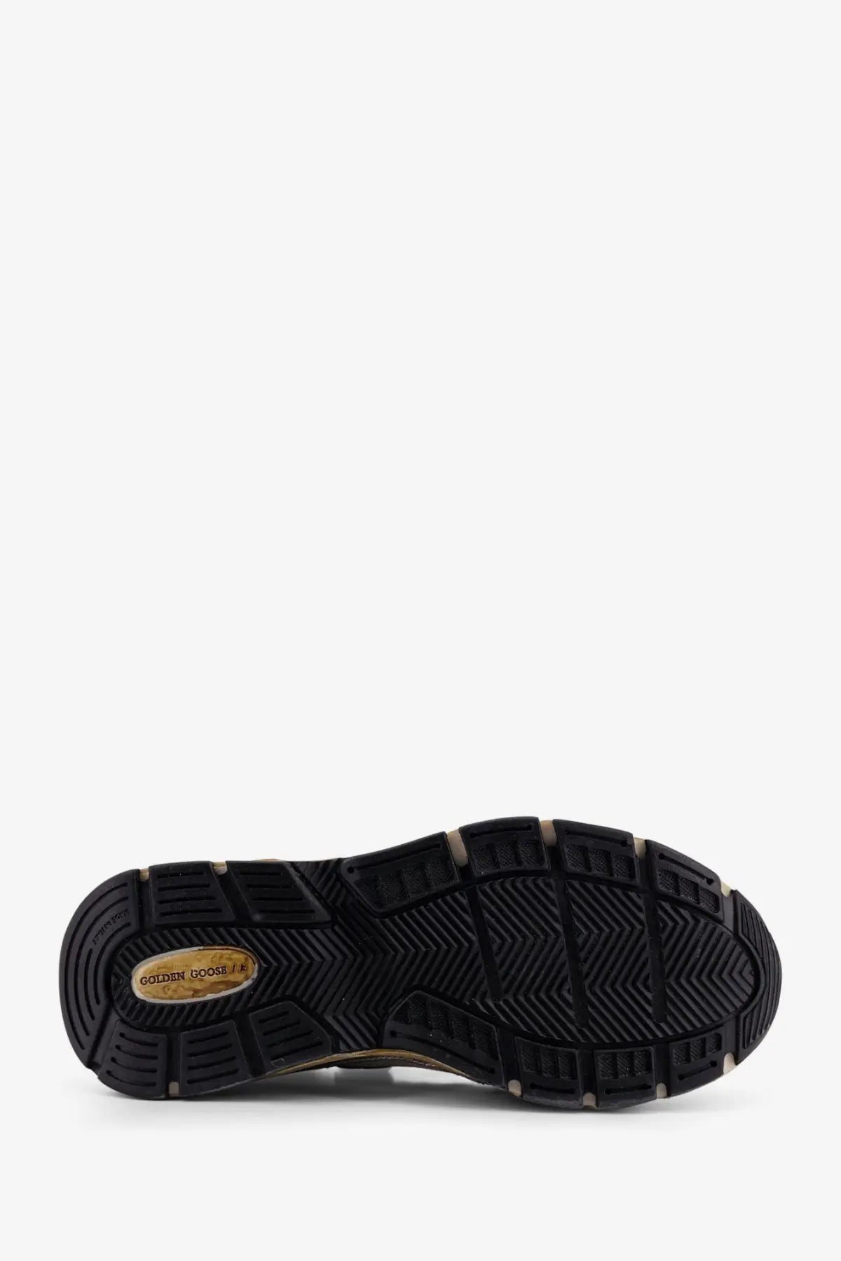 Black rubber sole with textured herringbone pattern and gold golden goose logo plaque on golden goose womens white mesh leather running dad sneakers