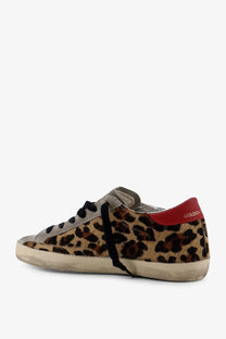 Golden goose women’s super star sneaker white leopard-print suede low-top with black laces and red heel tab back view