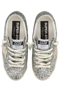 Golden Goose women’s superstar sneaker in silver glitter with white laces and beige star side detail