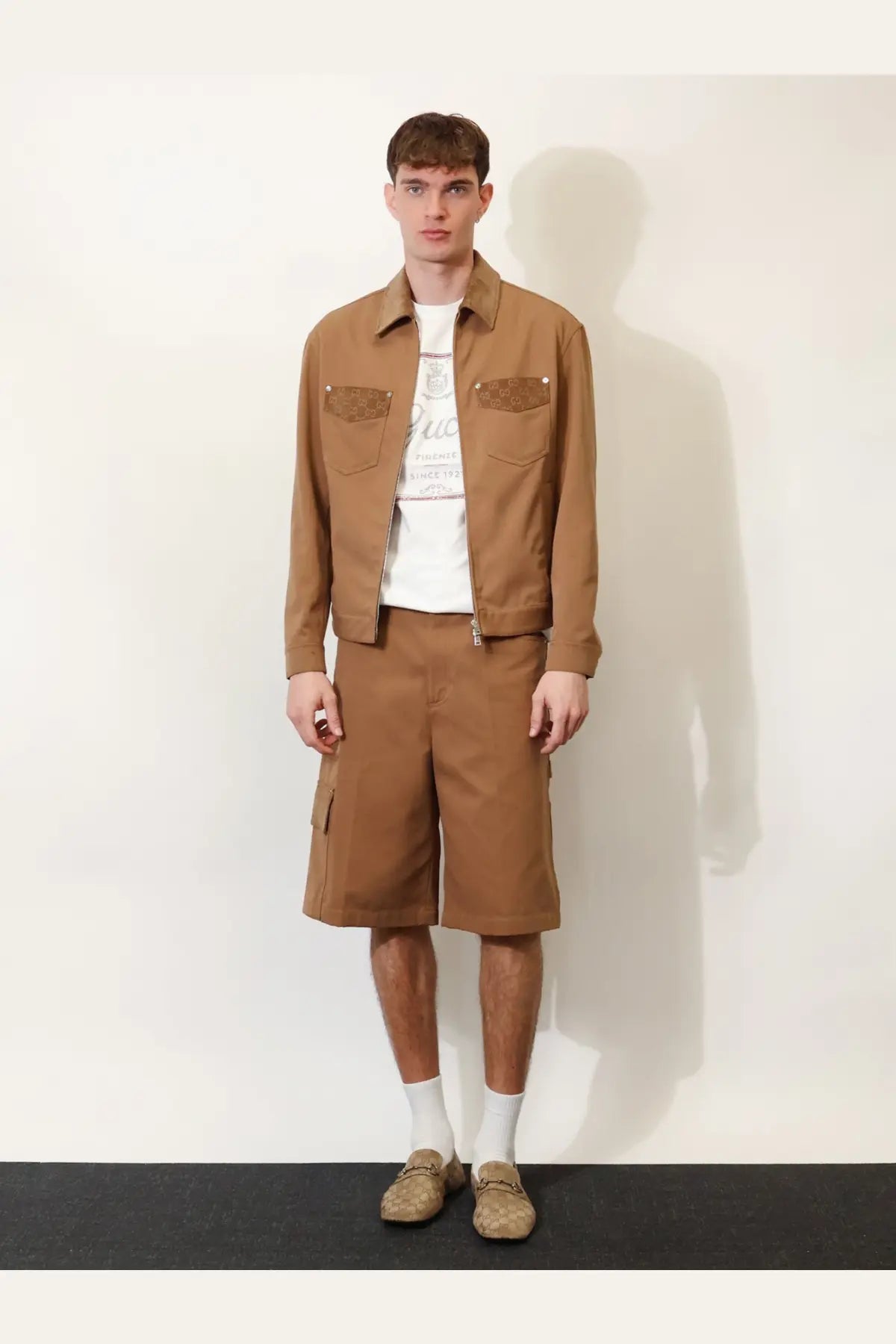Brown utility jacket with textured patch pockets paired with beige gucci men’s canvas cargo shorts