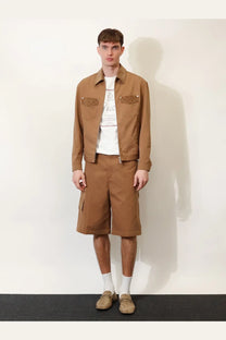 Brown utility jacket with textured patch pockets paired with beige gucci men’s canvas cargo shorts