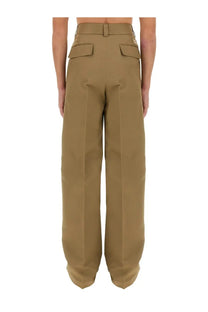 Gucci men’s beige cargo pants with tan wide-leg trousers, structured waistband, and two front flap pockets