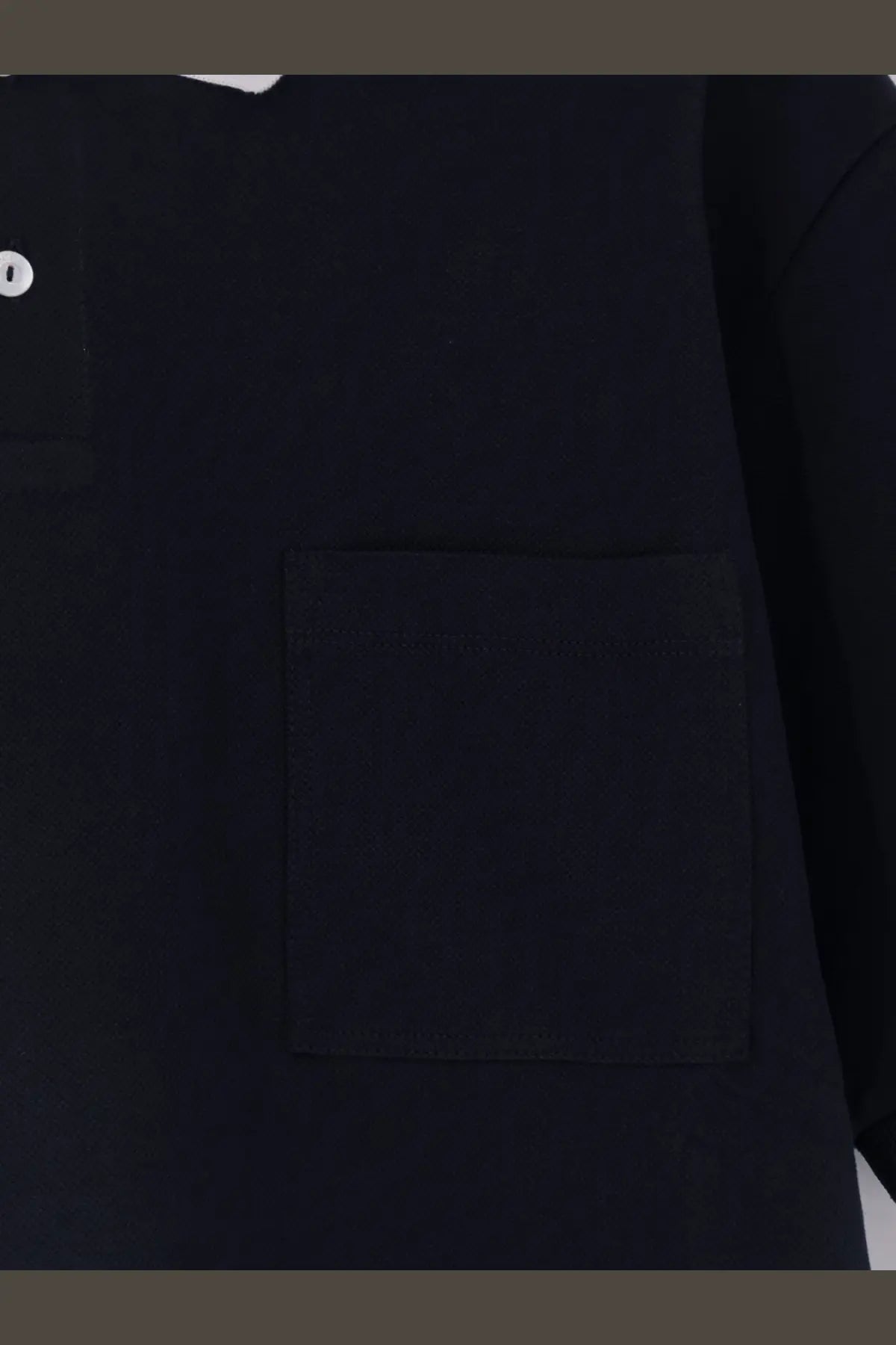 Gucci men’s black cotton piquet polo shirt featuring textured fabric and a single white button at the collar
