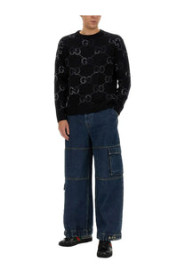 Black gucci mens sweater with repeating interlocking gg logo pattern paired with blue denim pants