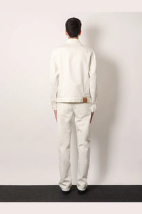 A crisp white denim jacket with a brown leather patch at the waistband shown from the back side