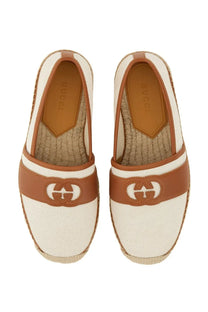 Cream-colored Gucci men’s espadrille loafers with brown leather accents and woven jute sole