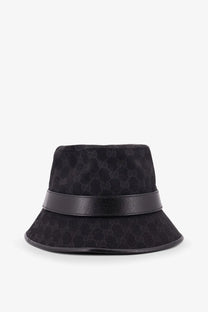 Gucci men’s black bucket hat with subtle monogram pattern and sleek leather band in GG original fabric cloche style