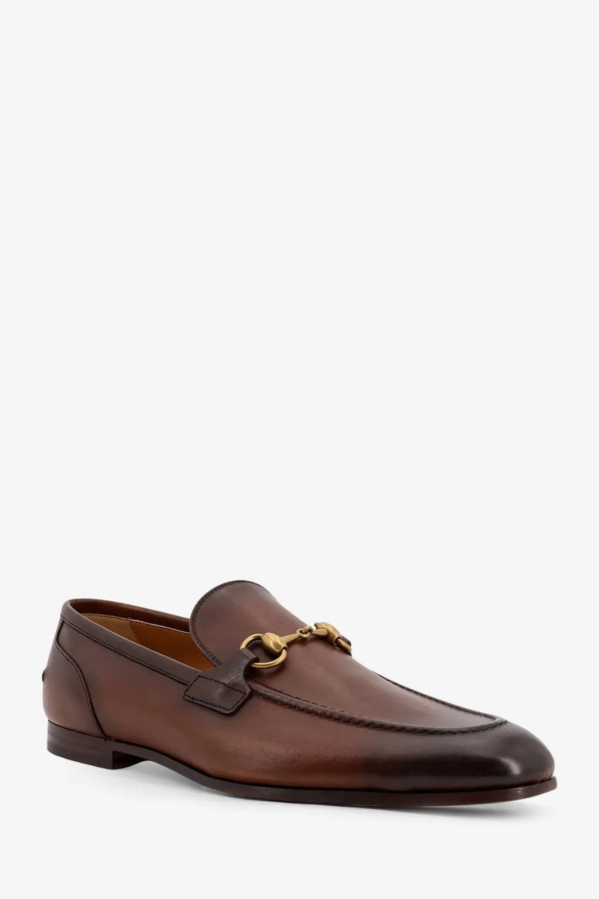 Gucci men’s Jordaan brown leather loafers featuring a gold-tone horsebit buckle for stylish wear