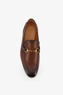 Gucci men’s Jordaan brown leather loafers with a gold-tone horsebit buckle for stylish comfort