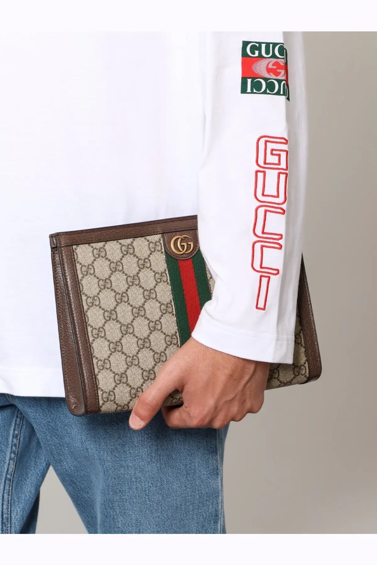 Gucci men’s Ophidia GG fabric clutch in beige with brown leather trim and red green striped accent