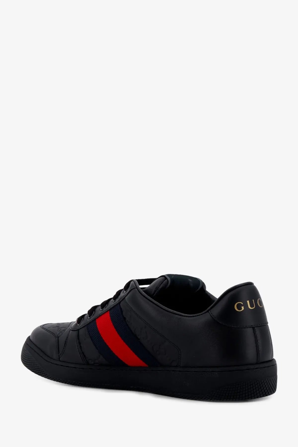 Black gucci men’s screener leather sneaker with glossy upper, bold red and navy stripes, and gold lettering on heel back view