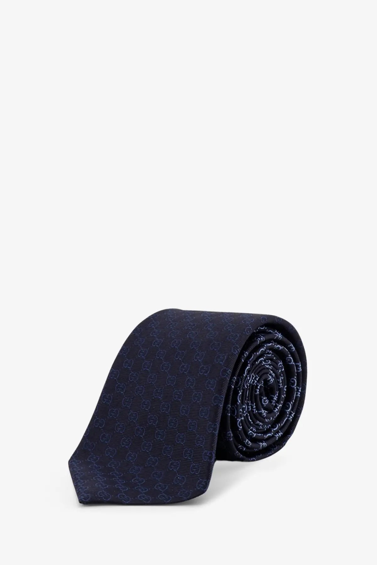 Gucci men’s shady silk tie in dark blue with a subtle repeating Gucci logo pattern