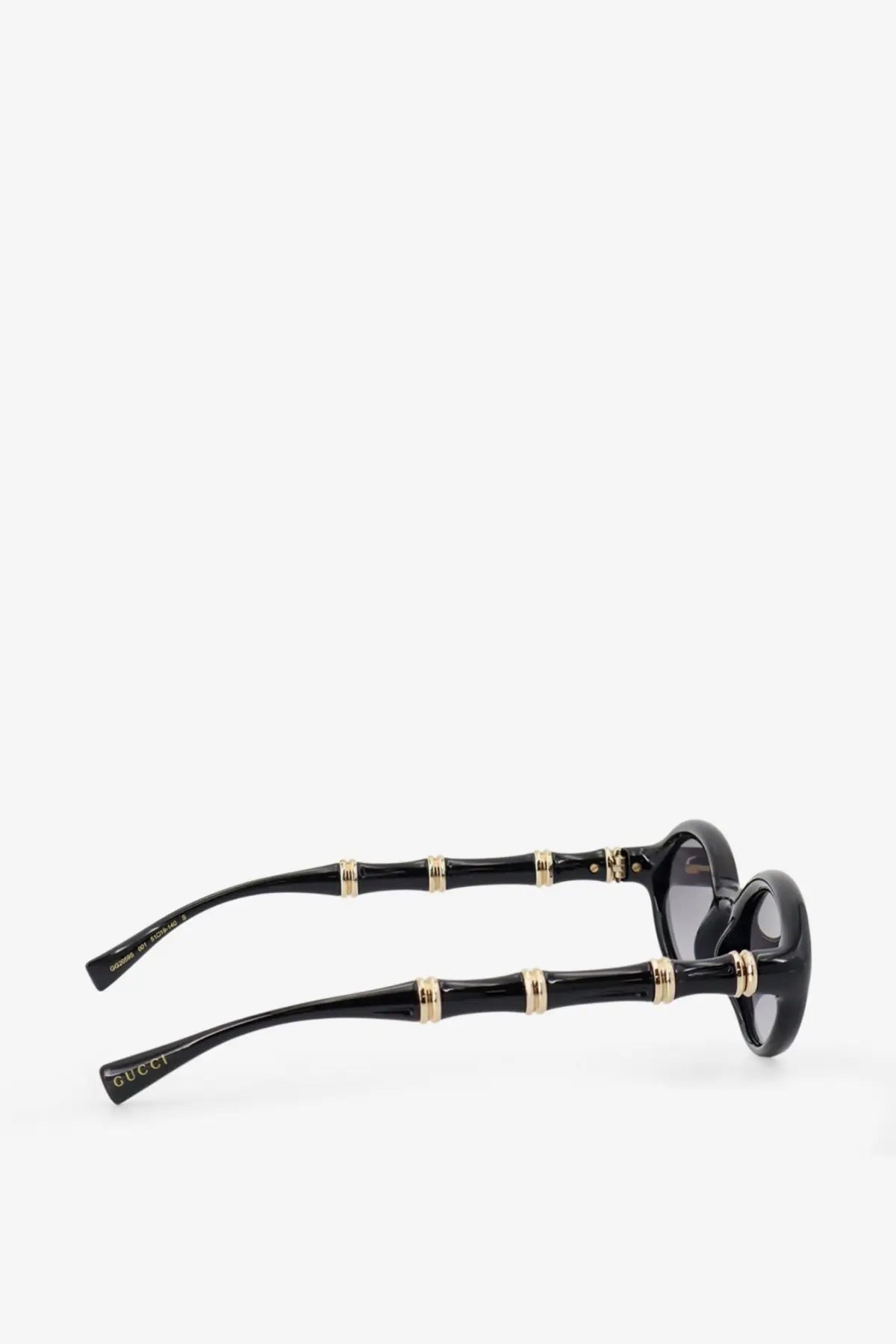 Gucci women’s acetate sunglasses in black with a bamboo pattern gold-tone accents and dark lenses