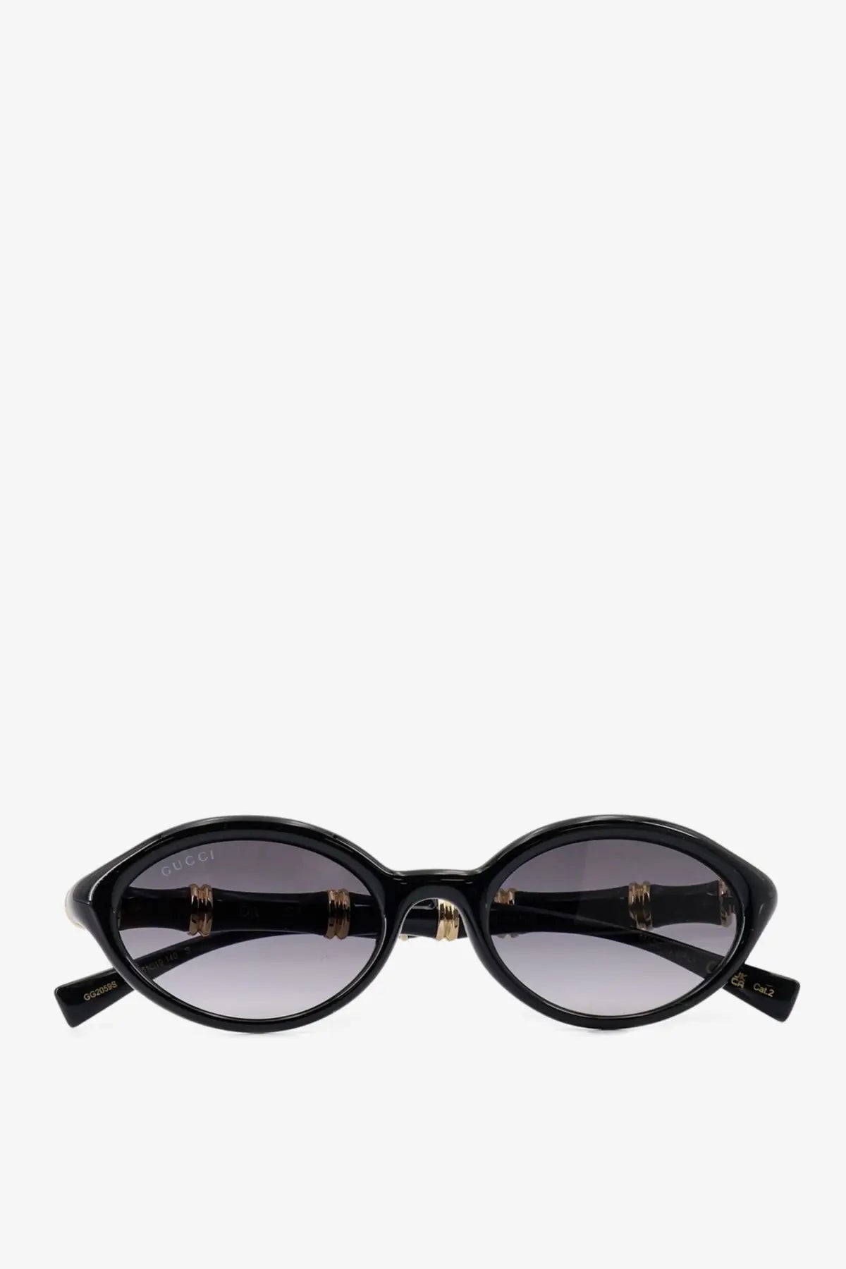 Gucci women’s black acetate oval sunglasses with gold-tone bamboo-inspired temples and gradient gray lenses