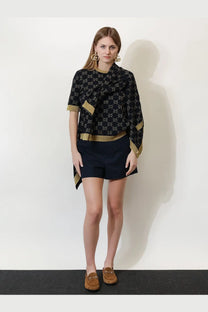 Black gucci women’s cotton blend shorts with gold interlocking g logo pattern and gold-trimmed sleeves with draped neckline