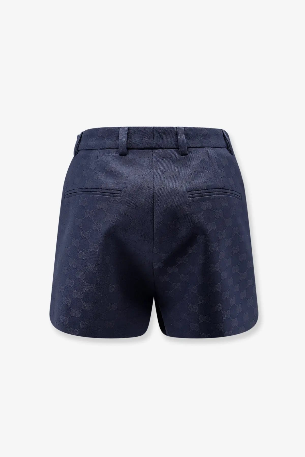 Dark blue gucci women’s gg cotton blend shorts with subtle pattern textured fabric tailored waistband and back pockets back view
