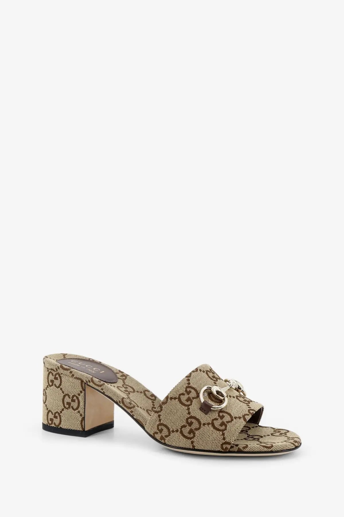 Beige and brown Gucci women’s GG fabric mule sandal with gold-tone horsebit buckle in supreme canvas material