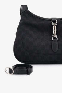 Gucci women’s Jackie GG fabric shoulder bag in black with subtle monogram canvas silver clasp and matching black leather belt