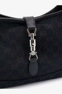 Black Gucci women’s Jackie GG fabric shoulder bag with black leather accents and silver-tone metal clasp