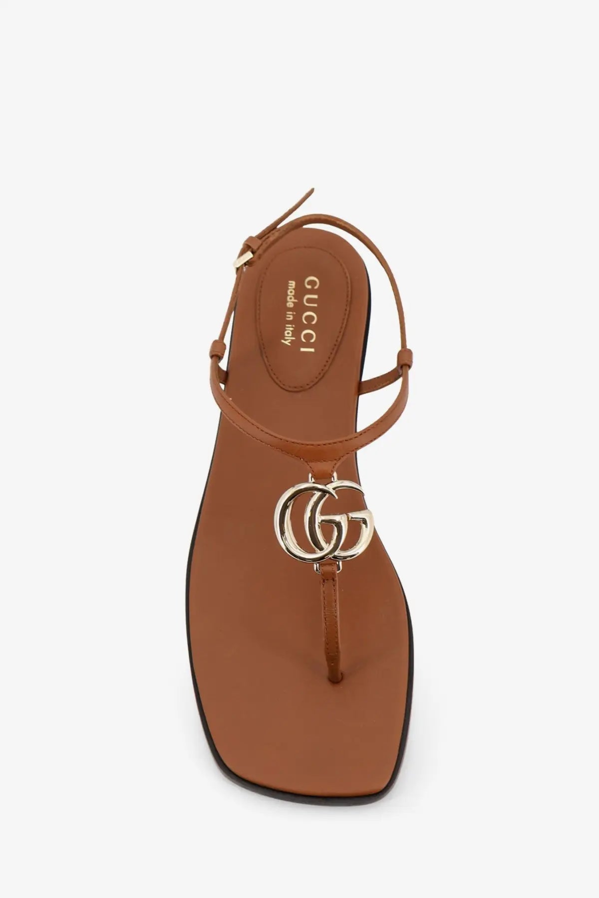 Brown Gucci leather thong sandal with metallic interlocking GG logo charm featured in Gucci womens Lifford sandals yellow