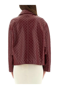 Back of gucci women’s oversized red leather jacket with embossed interlocking gg logo pattern