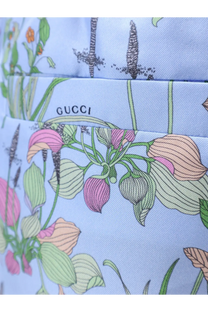 Light blue gucci handbag with delicate pink peach and green botanical print paired with gucci women’s printed silk shorts white