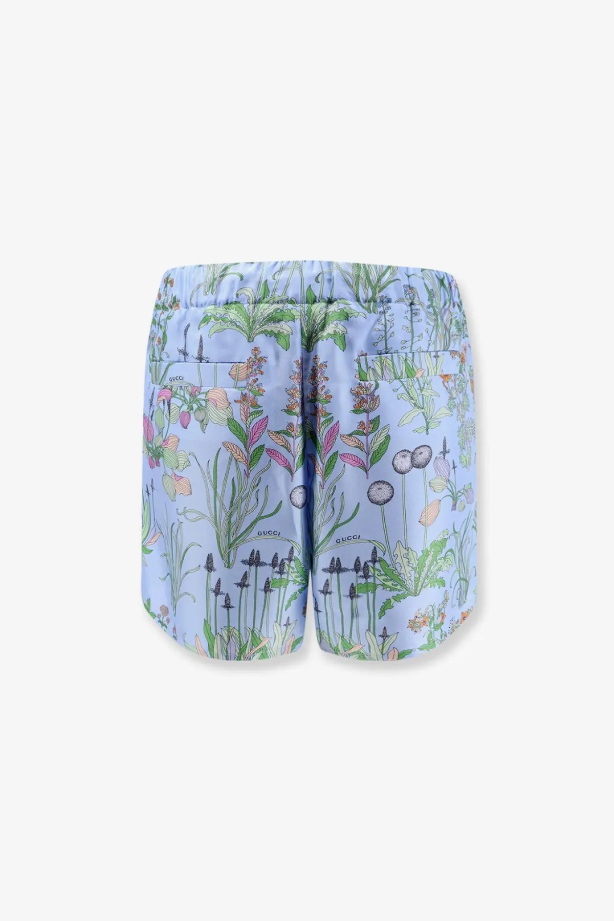 Light blue Gucci women’s printed silk swim trunks with detailed green pink and white botanical floral design