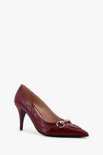 Burgundy Gucci pump with signature GG monogram embossed leather upper and gold-tone horsebit buckle detail