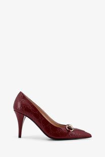 Burgundy Gucci womens Rosso Ancora GG leather écolleté pump with glossy finish embossed monogram and gold horsebit buckle