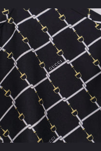 Black gucci women’s short silk twill dress with black gucci silk scarf featuring white and gold horsebit chains pattern
