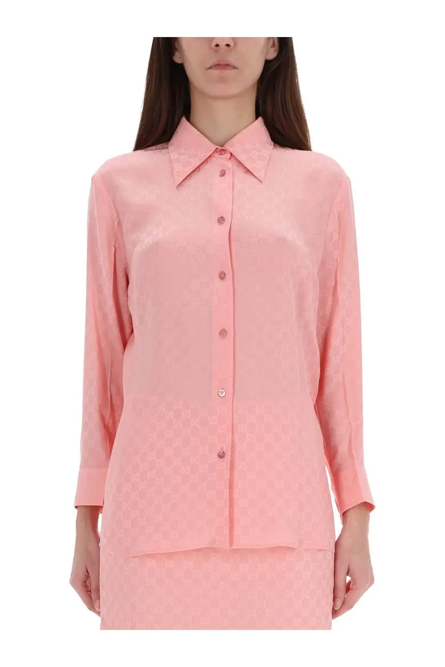 Gucci women’s soft pink silk blouse with subtle repeating pattern and classic button-down design