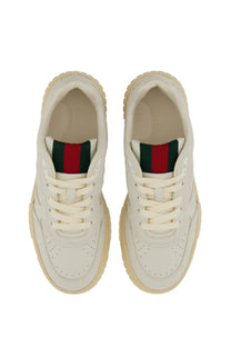 Cream-colored Gucci women’s sneaker re web white with classic leather upper red and green striped heel and chunky sole back view