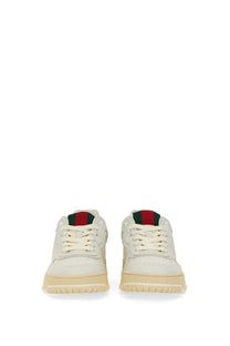 Cream-colored gucci women’s sneaker re web white low-top with iconic red and green web stripe on heel tab back view