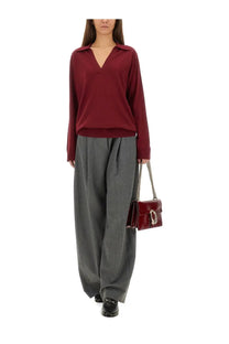 Burgundy leather handbag with silver chain strap and metallic clasp complementing gucci ultrafine wool polo shirt red