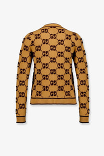 Back of a mustard yellow gucci women’s wool cardigan with black gg monogram pattern ribbed cuffs and hem