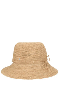 Beige woven straw sun hat with tied ribbon band and small decorative embellishment by Helen Kaminski