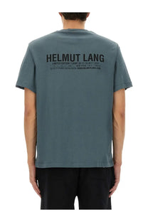 Back view of a muted teal helmut lang limited edition men’s capsule t-shirt with black printed text across the back
