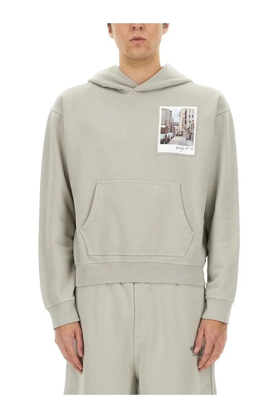 Helmut Lang men’s grey hoodie with a rectangular street scene photo patch on the chest in light gray fabric